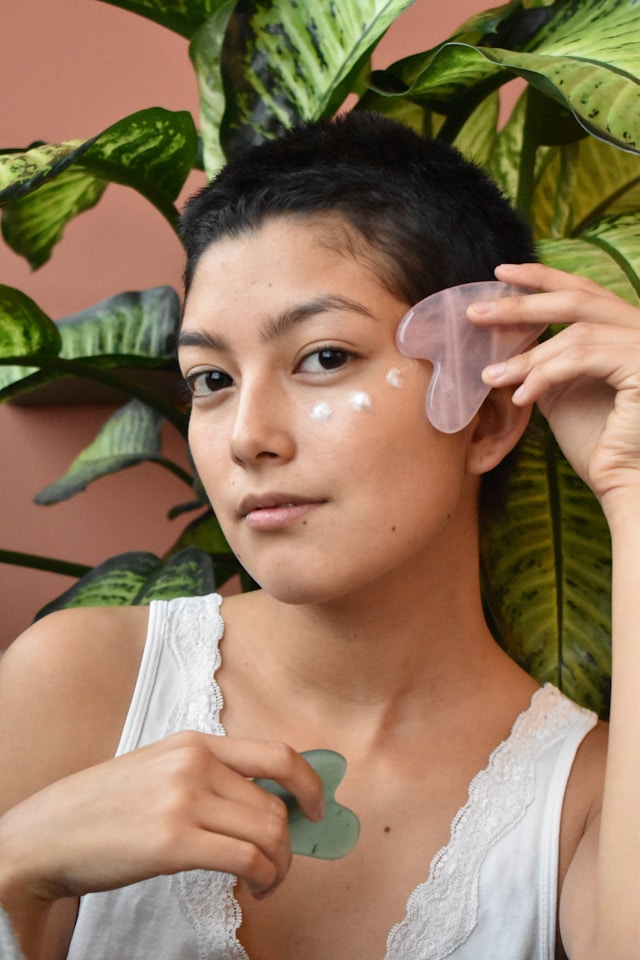 a-woman-holding-a-piece-of-plastic-in-front-of-her-face